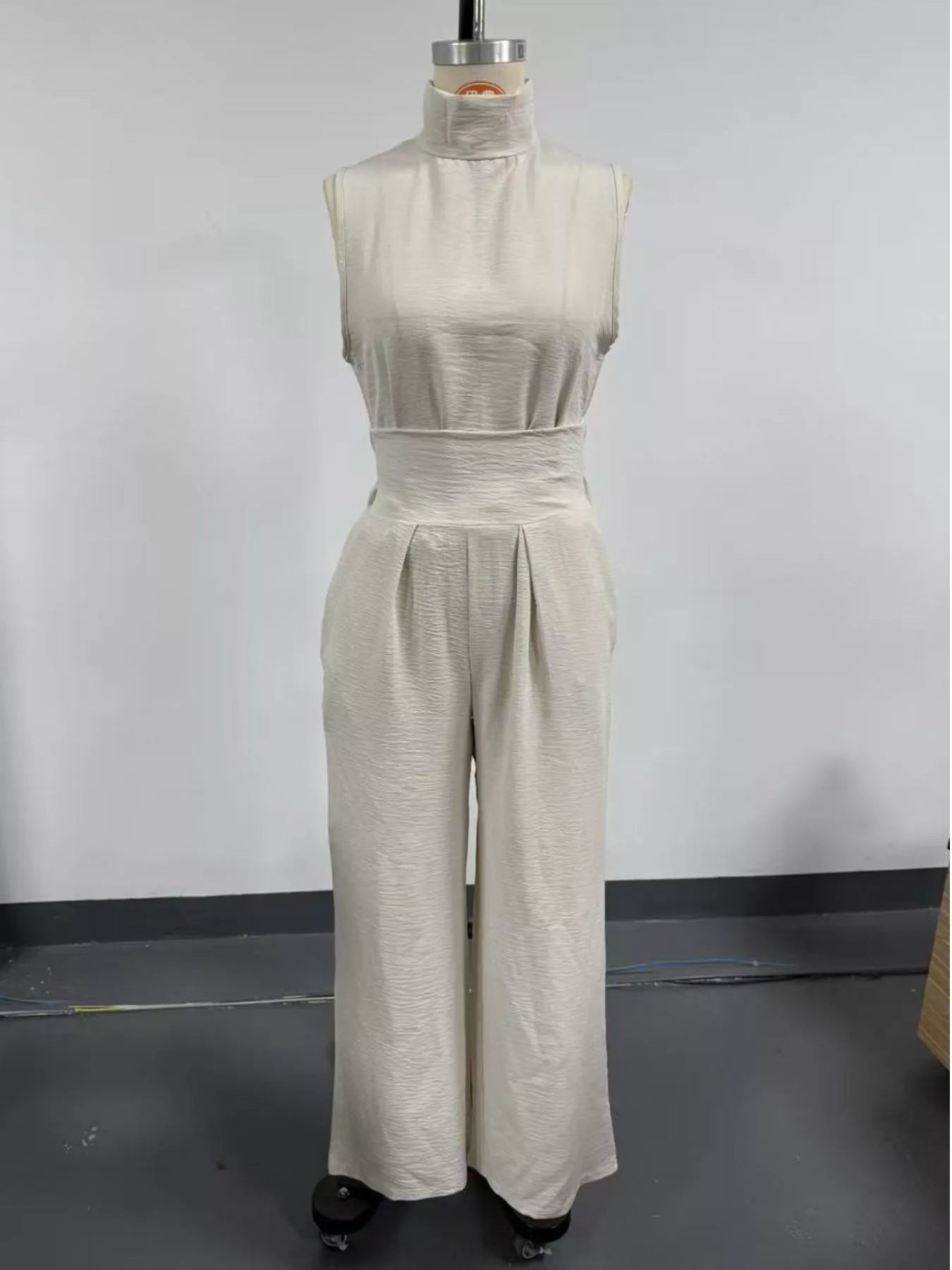 Full size sleeveless wide-leg jumpsuit with smocked waist from Trendsi, featuring a relaxed fit and stylish design.
