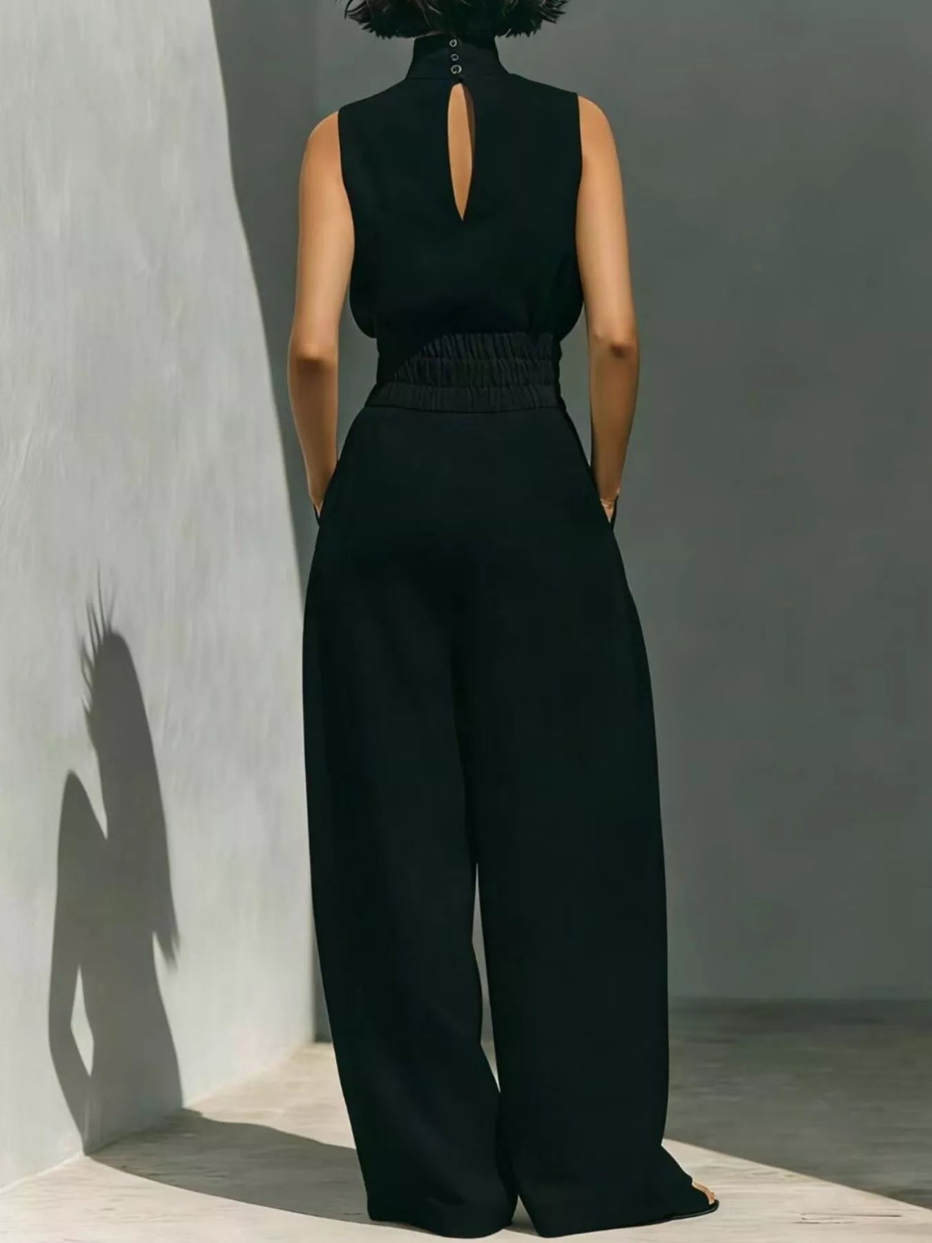 Plus size sleeveless wide-leg jumpsuit with smocked waist from Trendsi, shown in full view with fabric texture and relaxed fit.