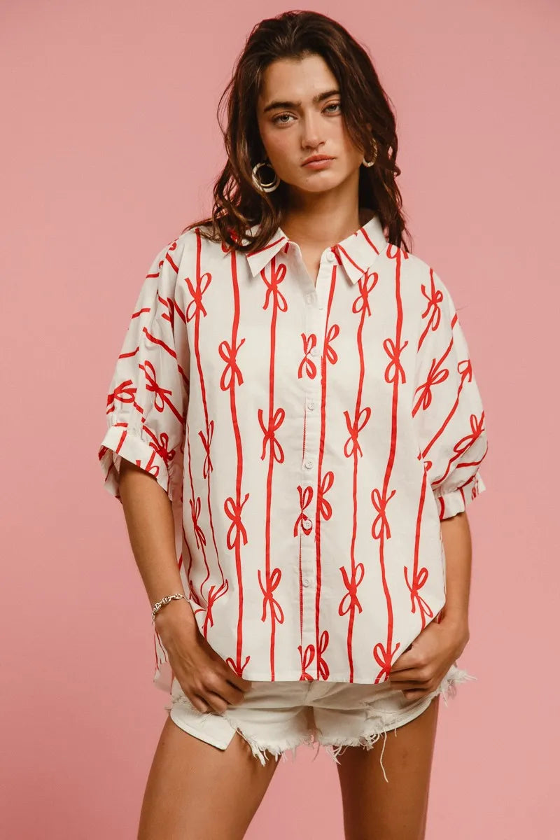 Woven printed button-down shirt with BiBi Bow Ribbon details from Trendsi, featuring a stylish design and lightweight fabric.