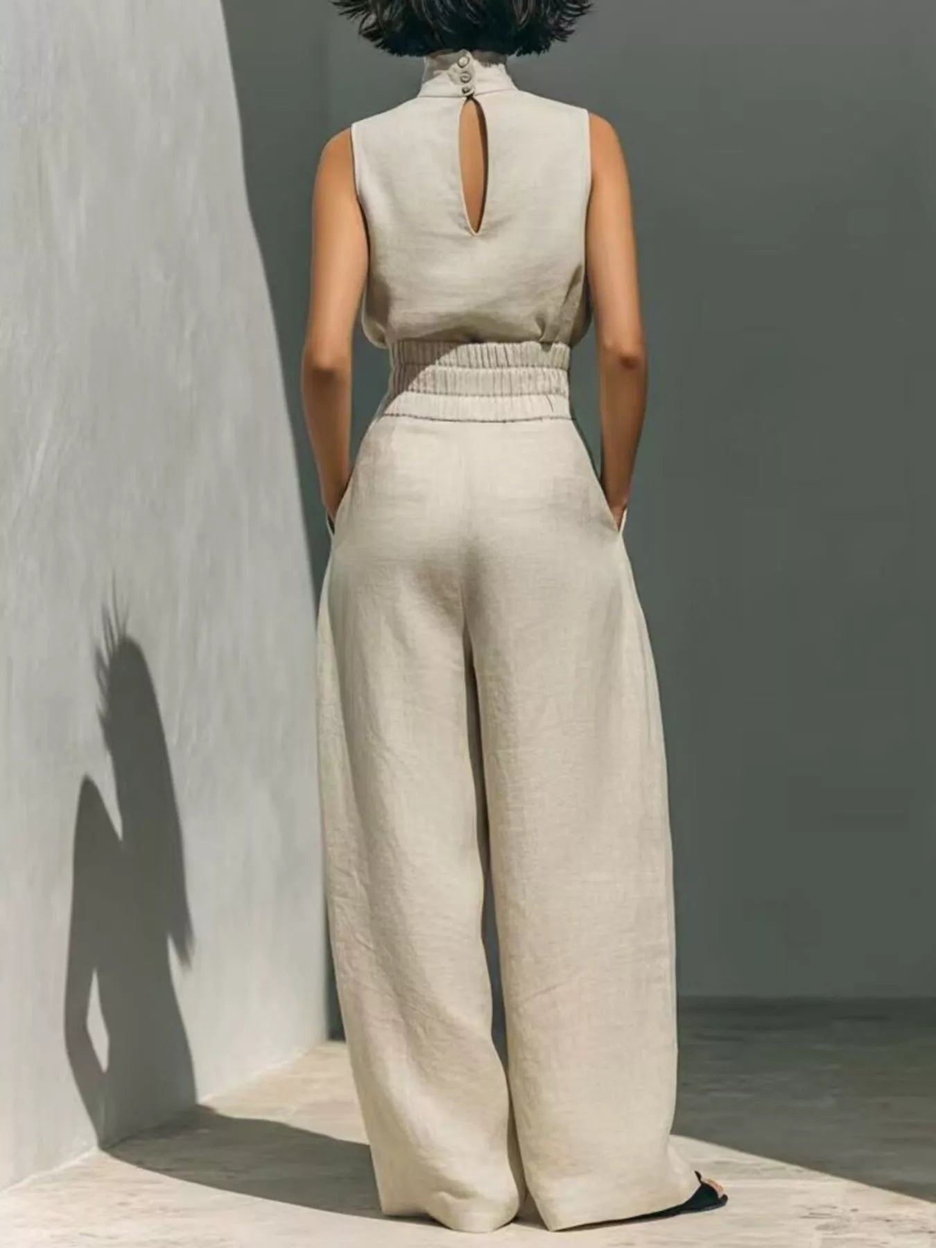 Plus size sleeveless wide-leg jumpsuit with smocked waist by Trendsi, shown in a full-length view.