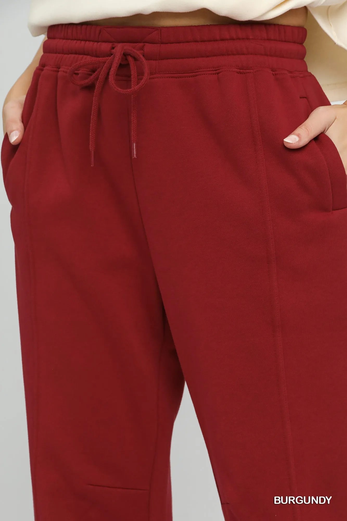 Umgee fleece jogger pants with drawstring, cozy casual loungewear in soft fabric, shown in black with elastic cuffs.