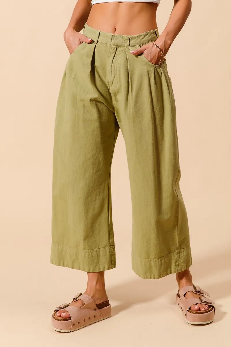 Trendsi SO ME mid-rise wide-leg chino pants with pockets, beige color, and tailored fit, displayed on a hanger.