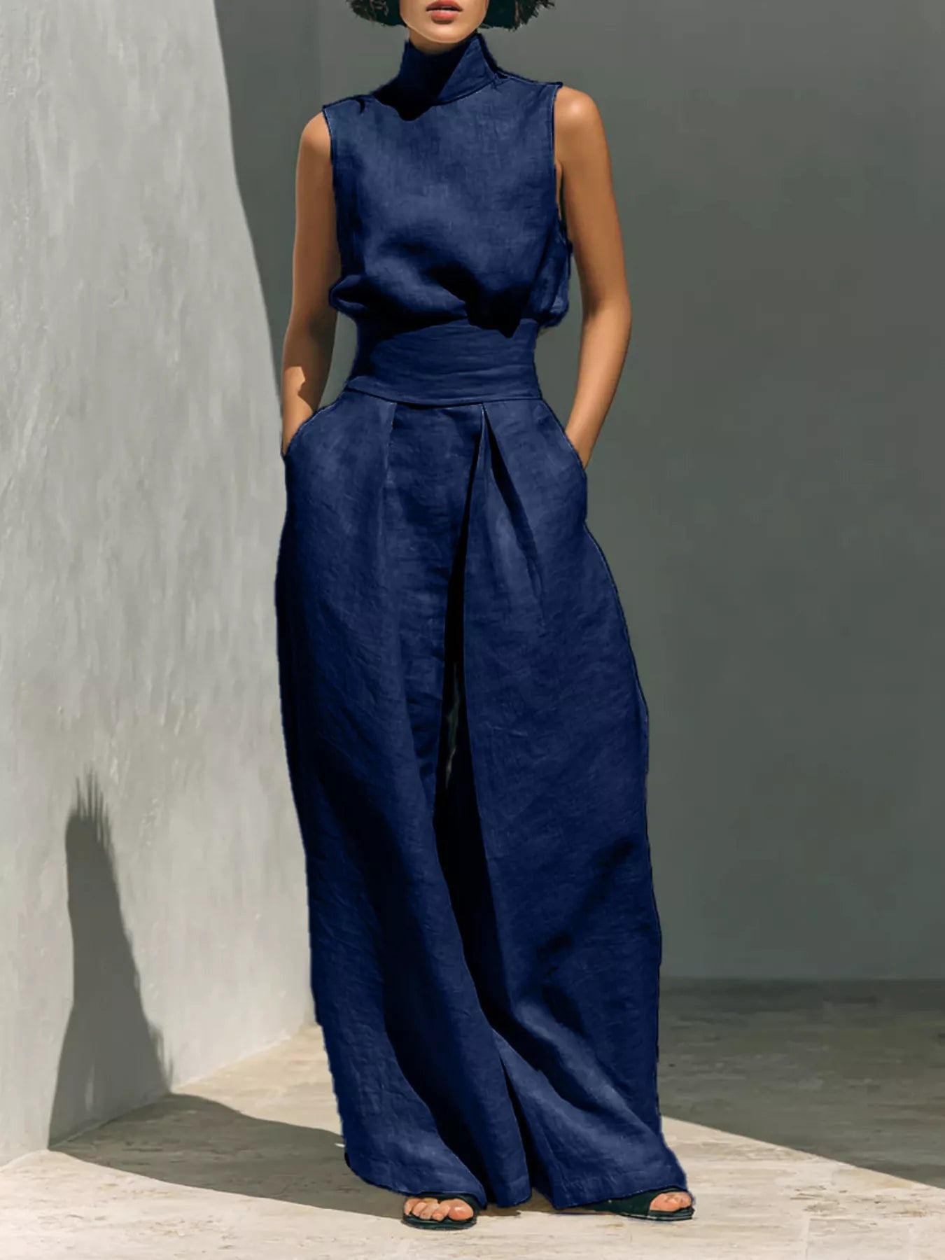 Full size sleeveless wide-leg jumpsuit with smocked waist by Trendsi, showcasing its relaxed fit and stylish design.