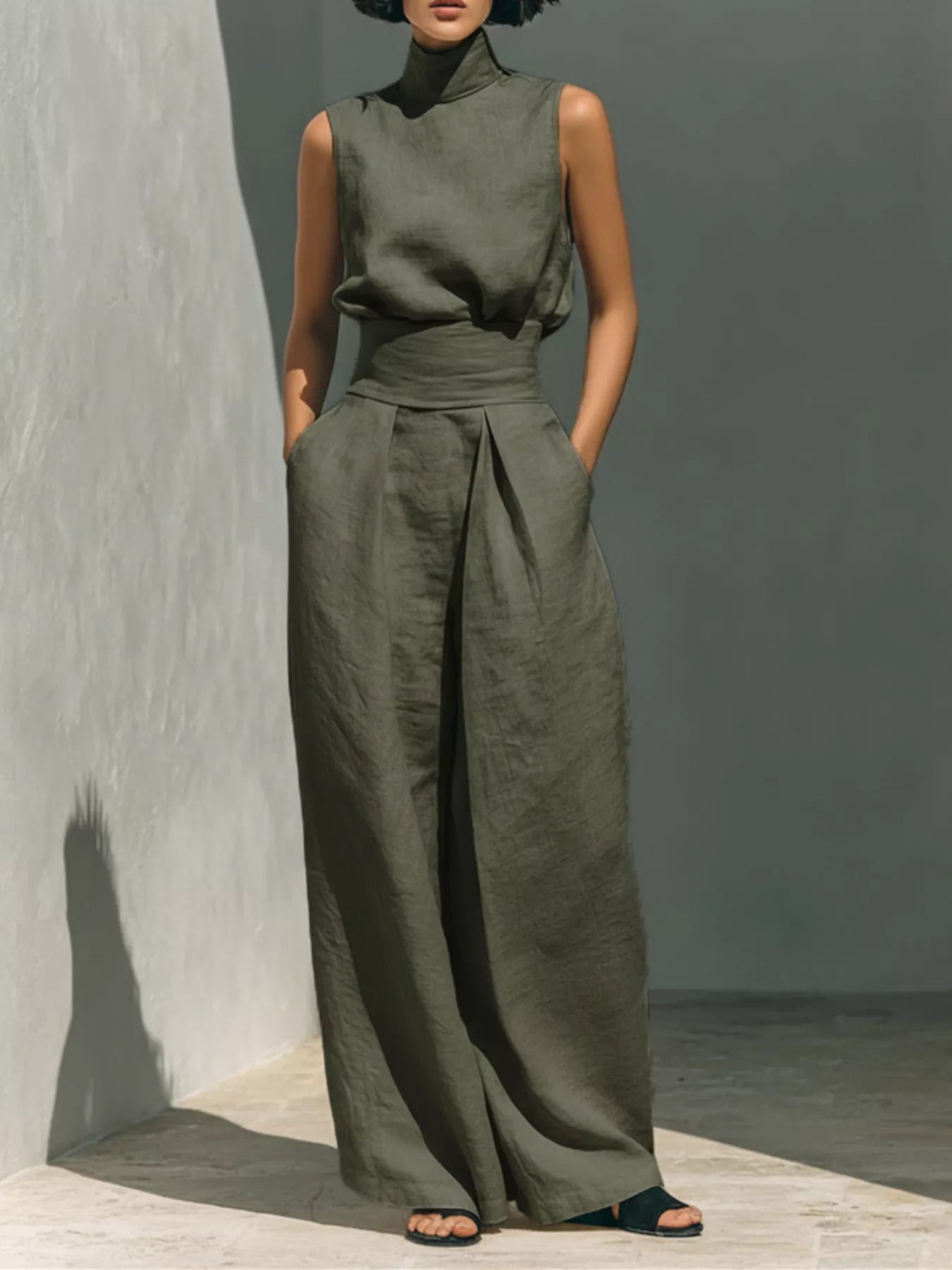 Plus size sleeveless wide-leg jumpsuit with smocked waist by Trendsi, shown in a full-length view with flowy fabric.