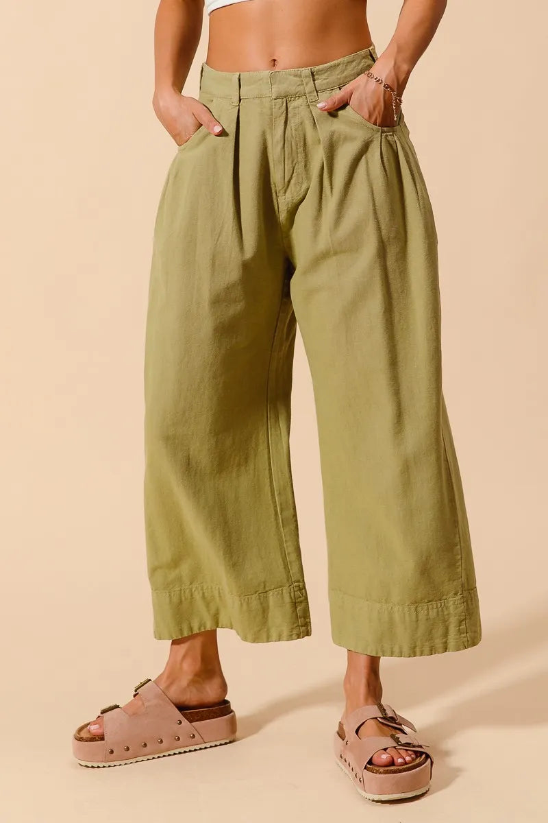 Trendsi SO ME mid-rise wide-leg chino pants with pockets, in a neutral color, displayed on a model.