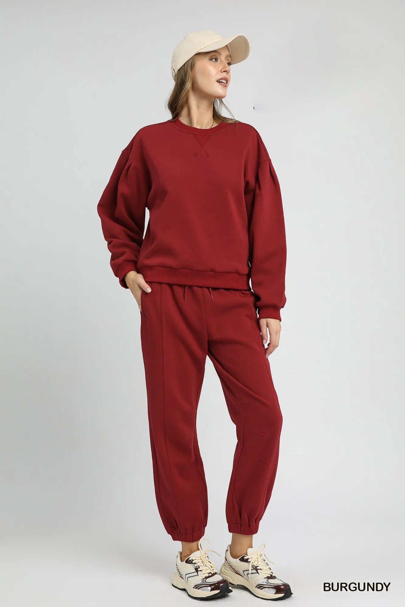 Trendsi Umgee round neck sweatshirt with pleated detail, soft fabric, and casual fit, shown in a neutral color.