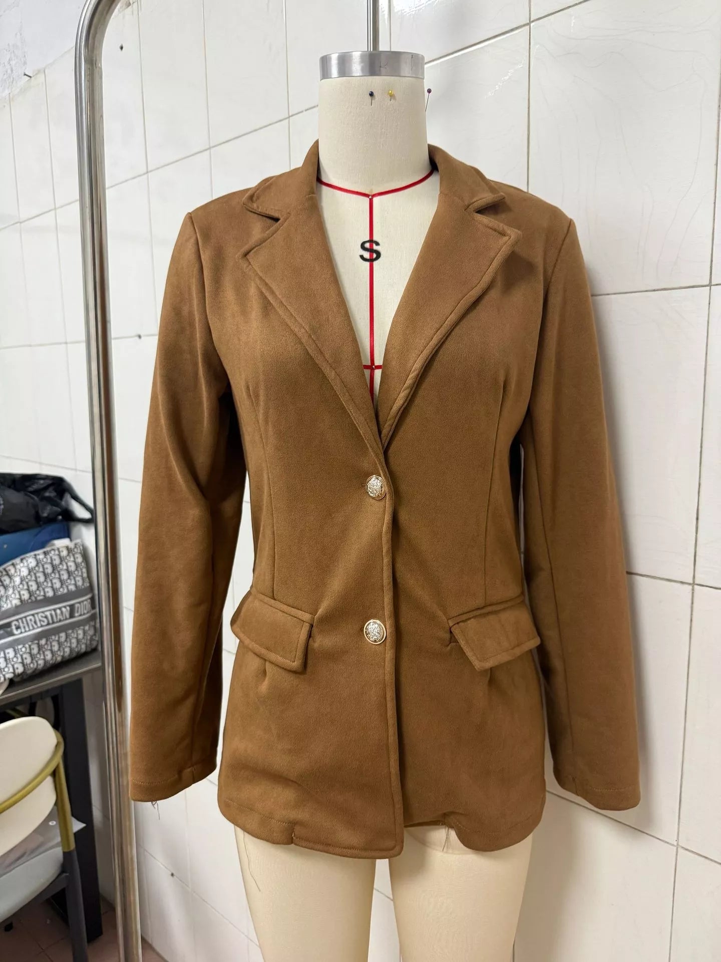 Black single-breasted blazer with lapel collar, tailored fit, and stylish design from Trendsi.