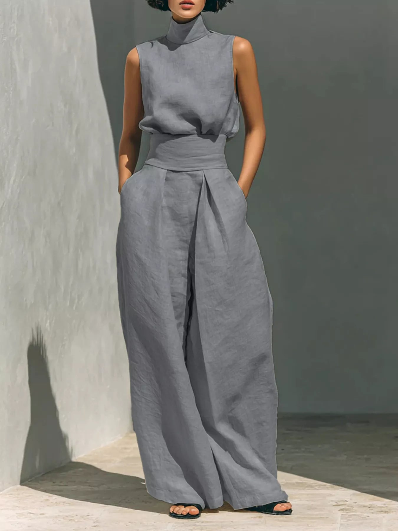 Plus size sleeveless wide-leg jumpsuit with smocked waist, trendy fashion by Trendsi, shown in a full-size image.