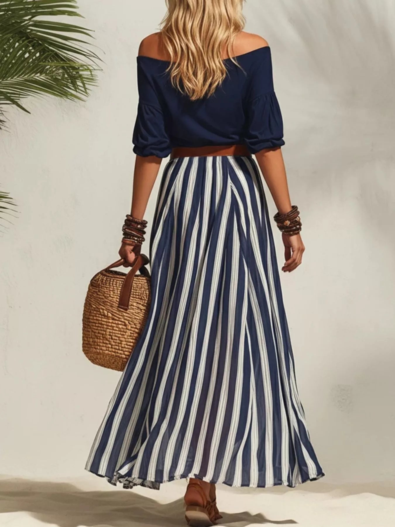 Off shoulder top and striped maxi skirt set by Trendsi, featuring a stylish off-shoulder top paired with a flowing striped maxi skirt.