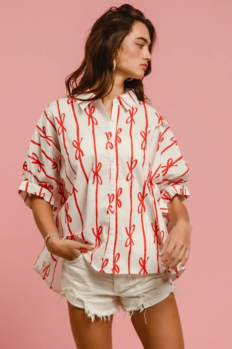 Woven printed button-down shirt with BiBi Bow Ribbon details by Trendsi, featuring a stylish, colorful pattern and classic collar.