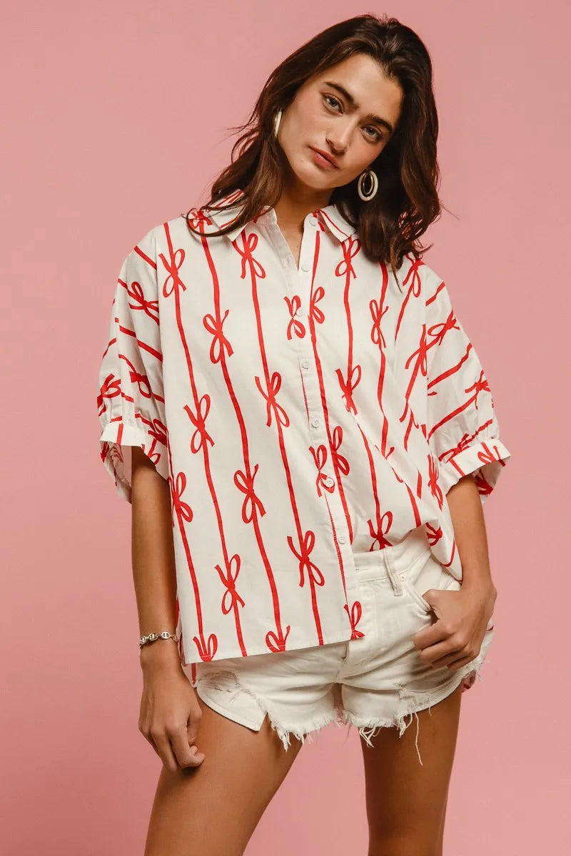 Woven printed button-down shirt from BiBi Bow Ribbon by Trendsi featuring a colorful pattern and classic collar.