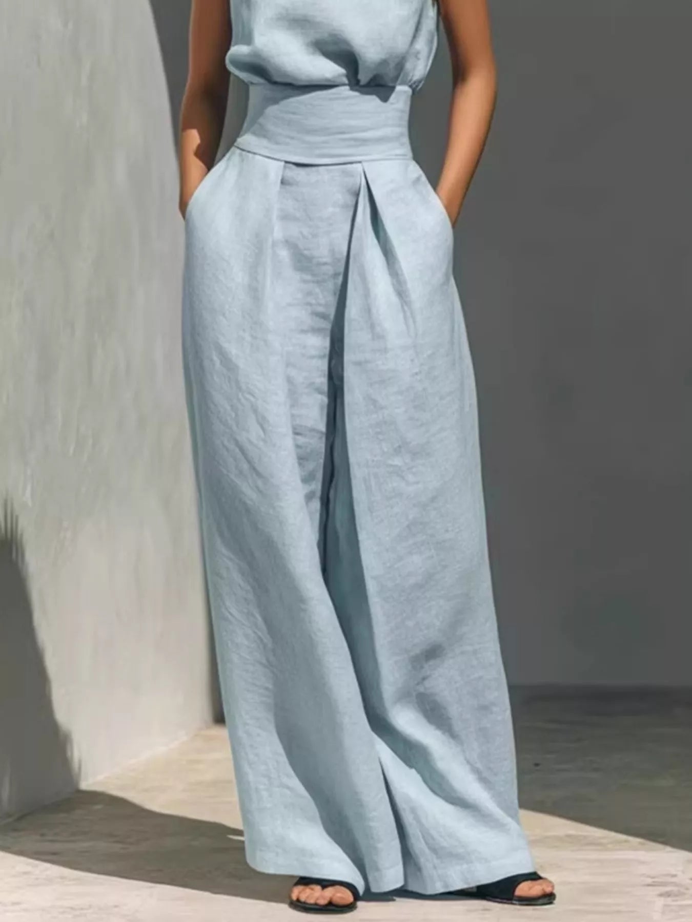 Plus size sleeveless wide-leg jumpsuit with smocked waist from Trendsi, shown in a full-length view highlighting the relaxed fit.