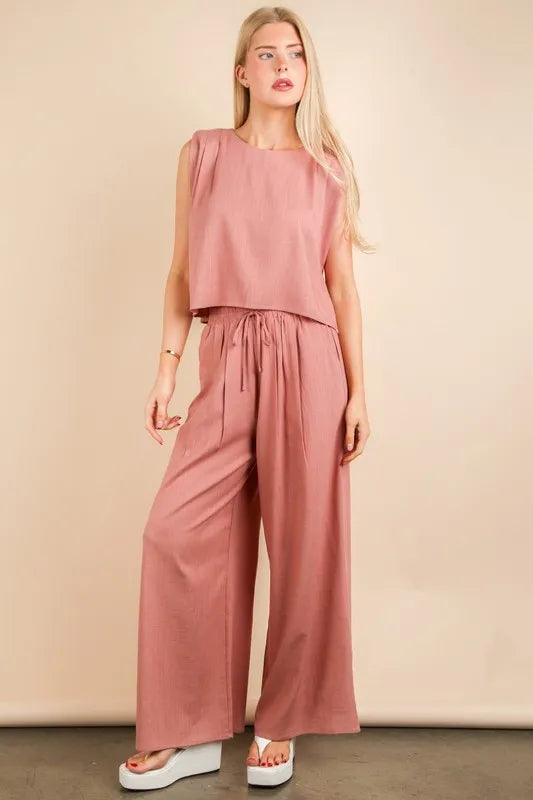 Woven top and pants set by Trendsi featuring a stylish, fitted design in a trendy, solid color, perfect for casual or chic outfits.