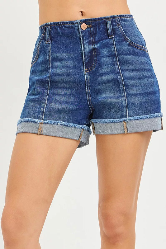 Risen slouchy cuffed denim shorts with distressed details and frayed hems, styled with a casual fit and light wash.