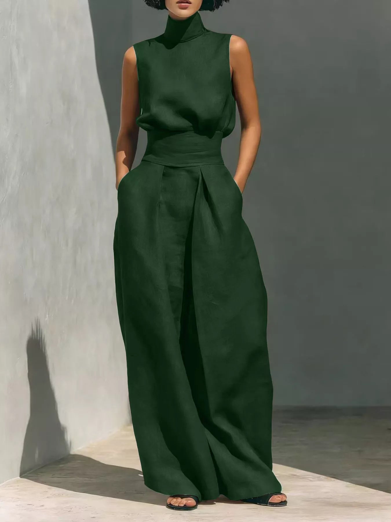 Plus size sleeveless wide-leg jumpsuit with smocked waist by Trendsi, featuring a full-length design and comfortable fit.