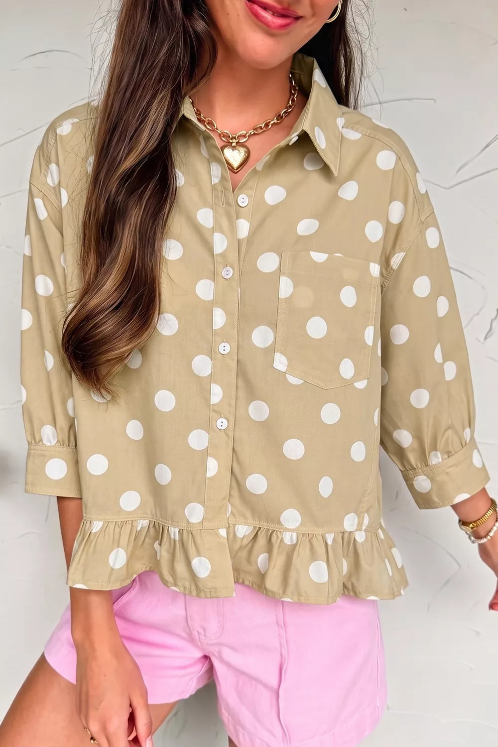 Polka dot print three-quarter sleeve casual shirt with ruffle hem from Trendsi, featuring a relaxed fit and playful pattern.