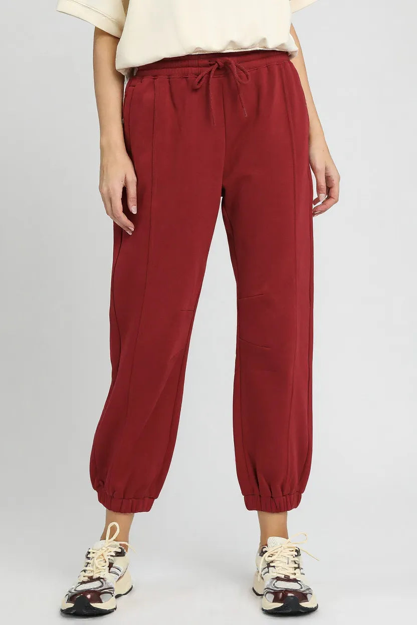Umgee fleece jogger pants with drawstring, cozy casual loungewear in soft fabric, styled with pockets and elastic cuffs.