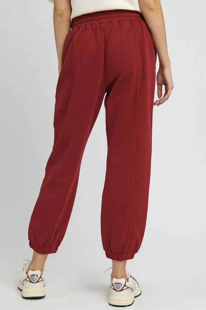 Umgee fleece jogger pants with drawstring, casual trendy loungewear from Trendsi, shown in a relaxed fit with elastic cuffs and side pockets.
