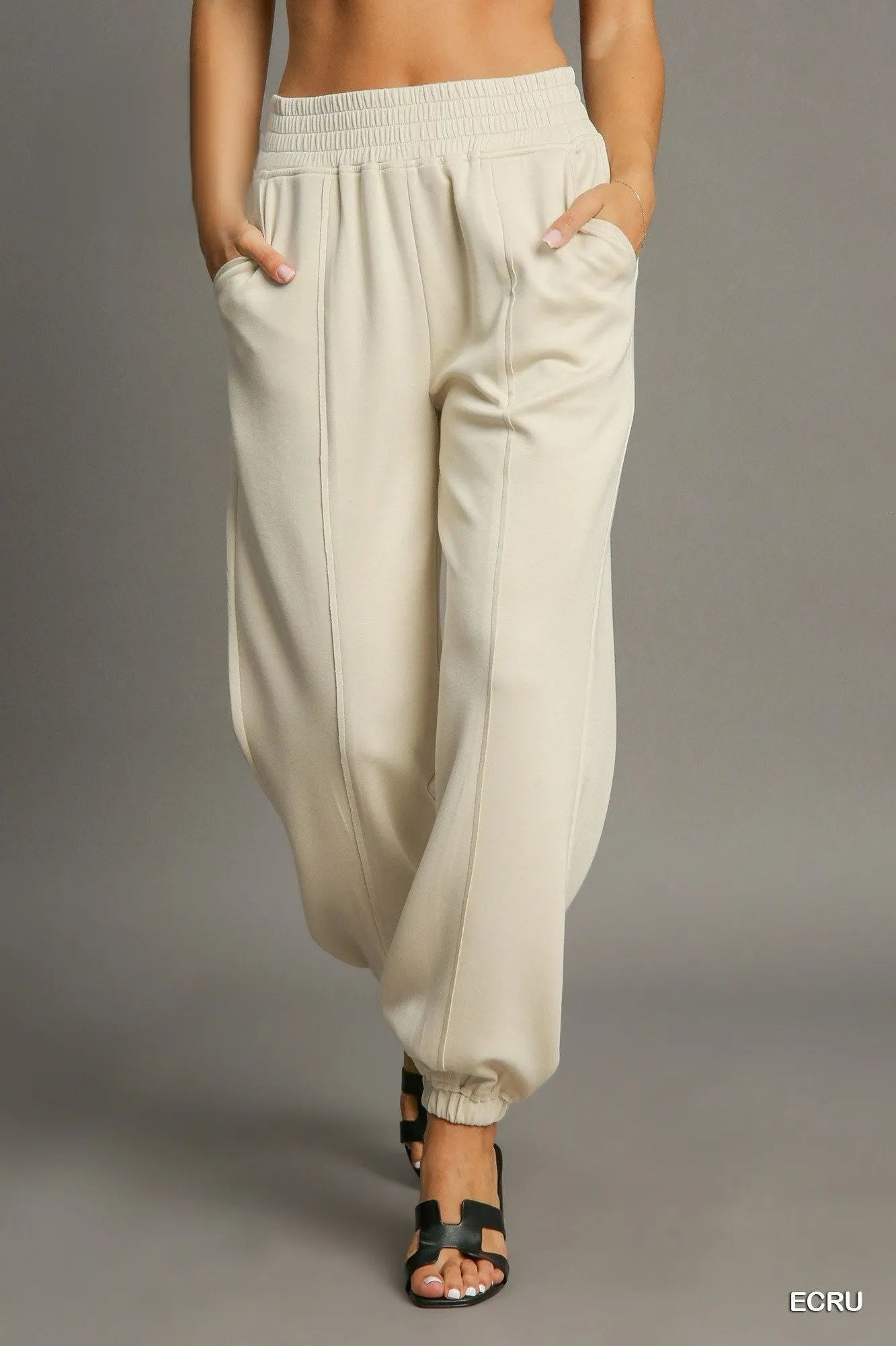 Umgee drawstring jogger pants with front seam detail, casual athletic style, in soft fabric, shown on a model.