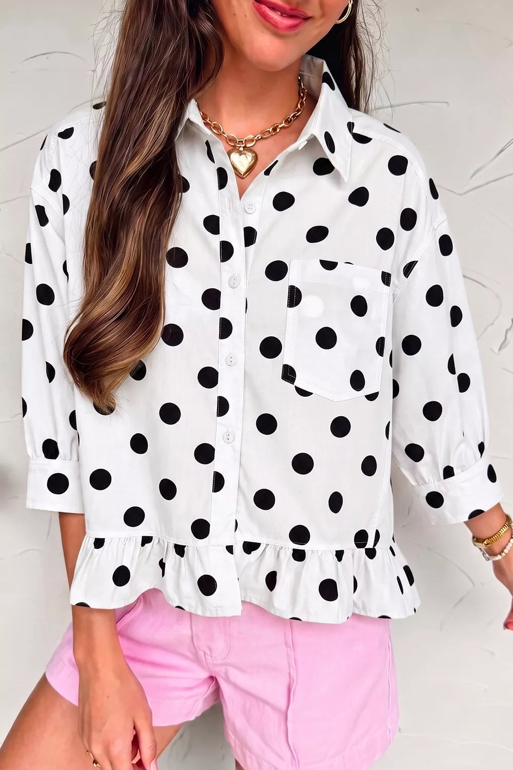 Polka dot print three-quarter sleeve ruffle hem casual shirt by Trendsi, featuring a relaxed fit and playful pattern.