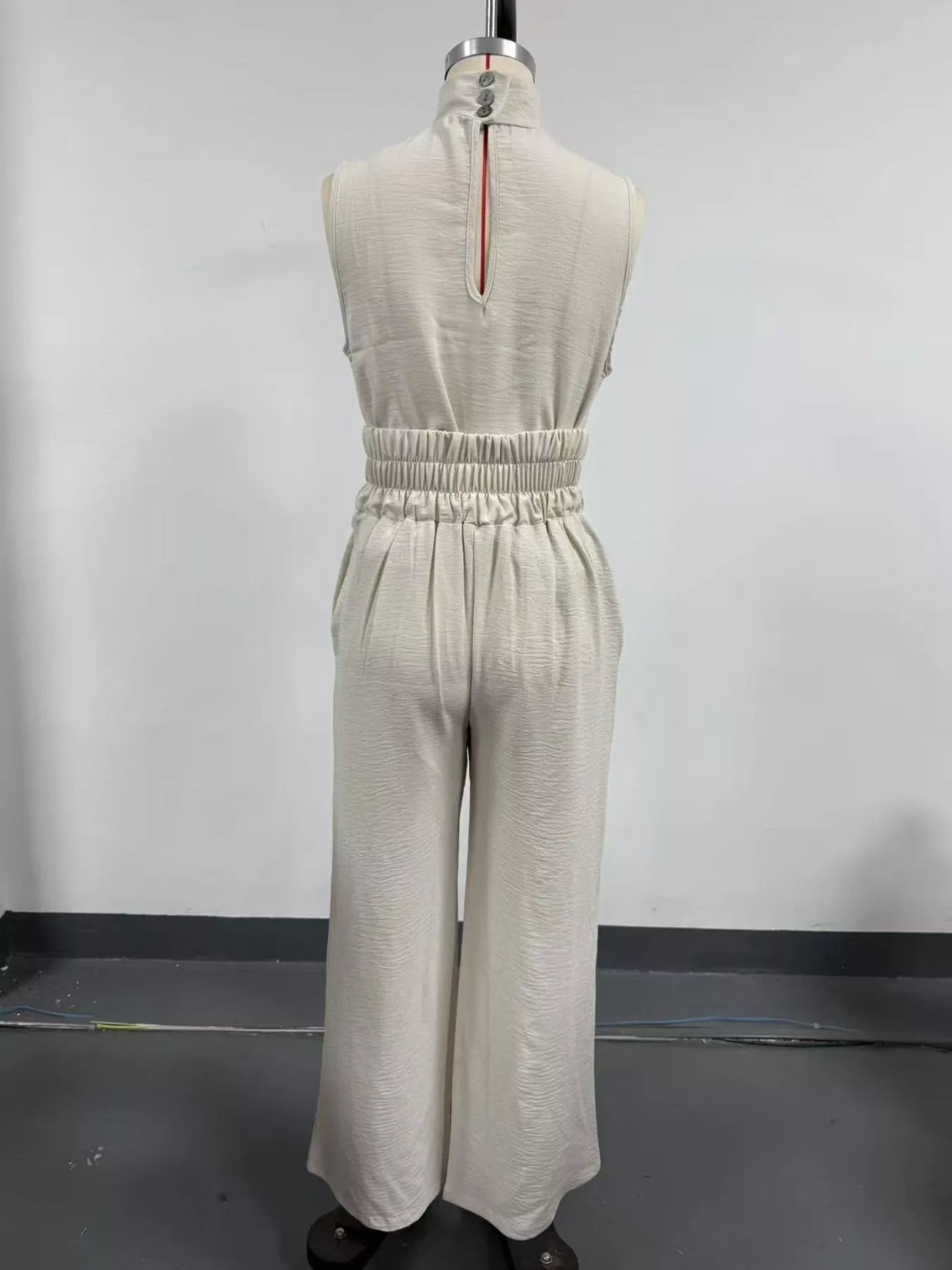 Plus size sleeveless wide-leg jumpsuit with smocked waist, trendy and comfortable, perfect for casual or dressy occasions.