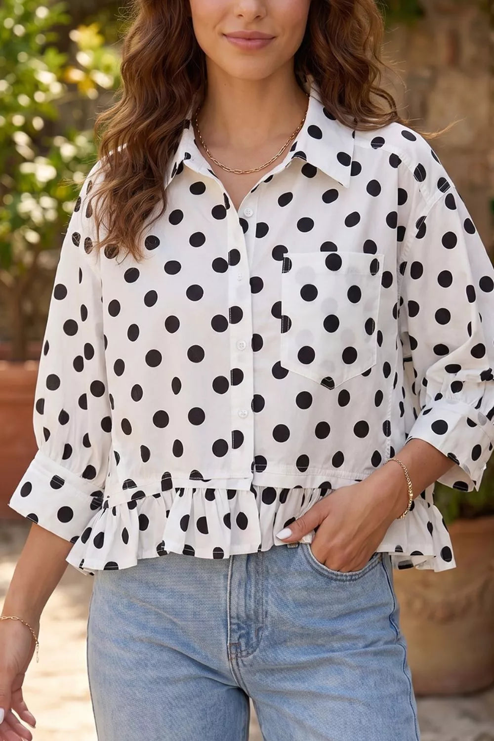 Polka dot print casual shirt with three-quarter sleeves and ruffle hem, by Trendsi, displayed on a hanger.