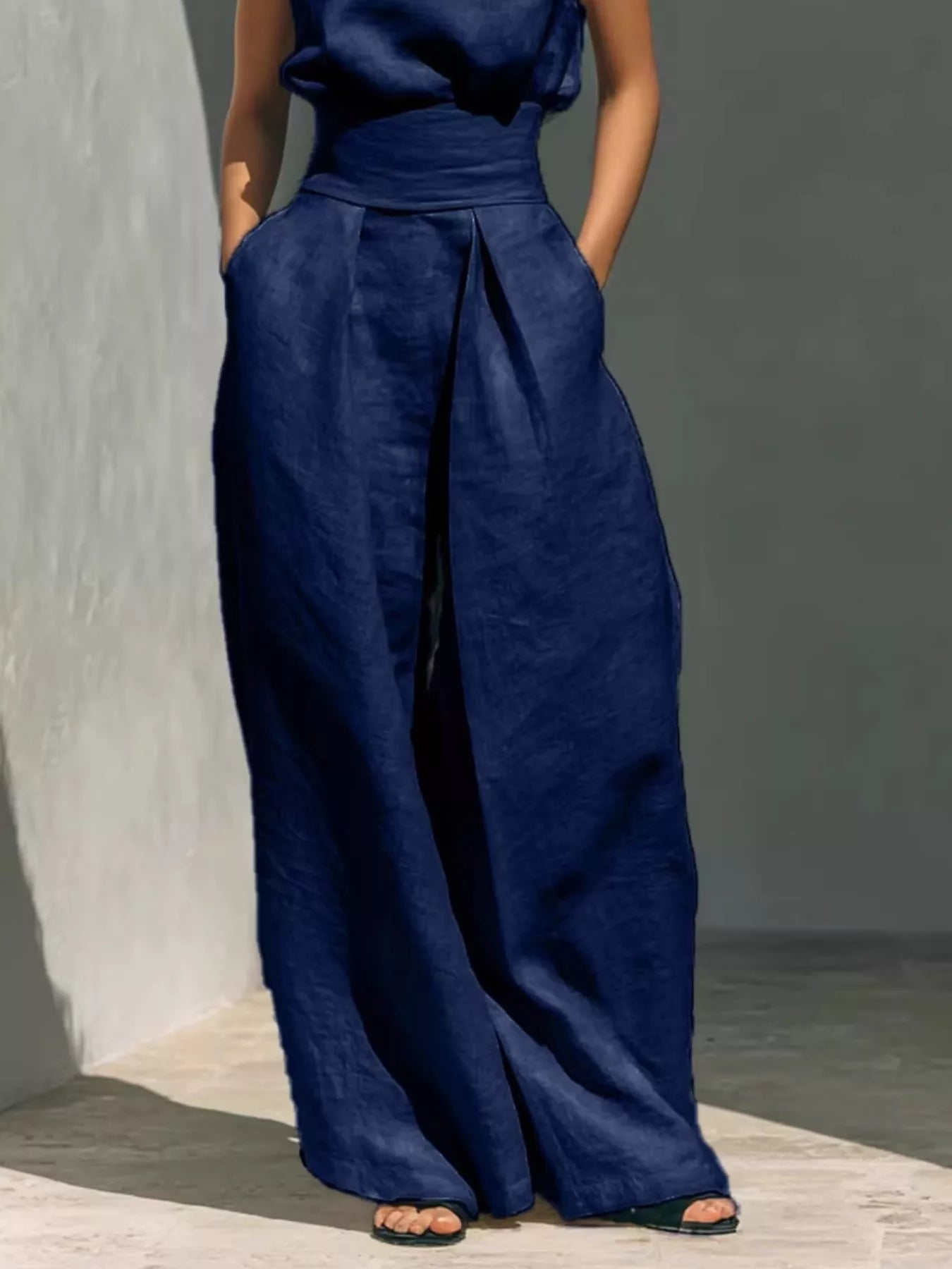 Full size sleeveless wide-leg jumpsuit with smocked waist, plus size, featuring a relaxed fit and stylish design from Trendsi.