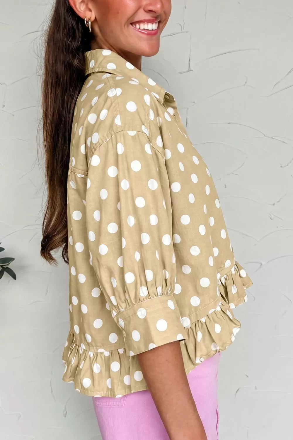 Polka dot print three-quarter sleeve casual shirt with ruffle hem from Trendsi, featuring a relaxed fit and stylish design.