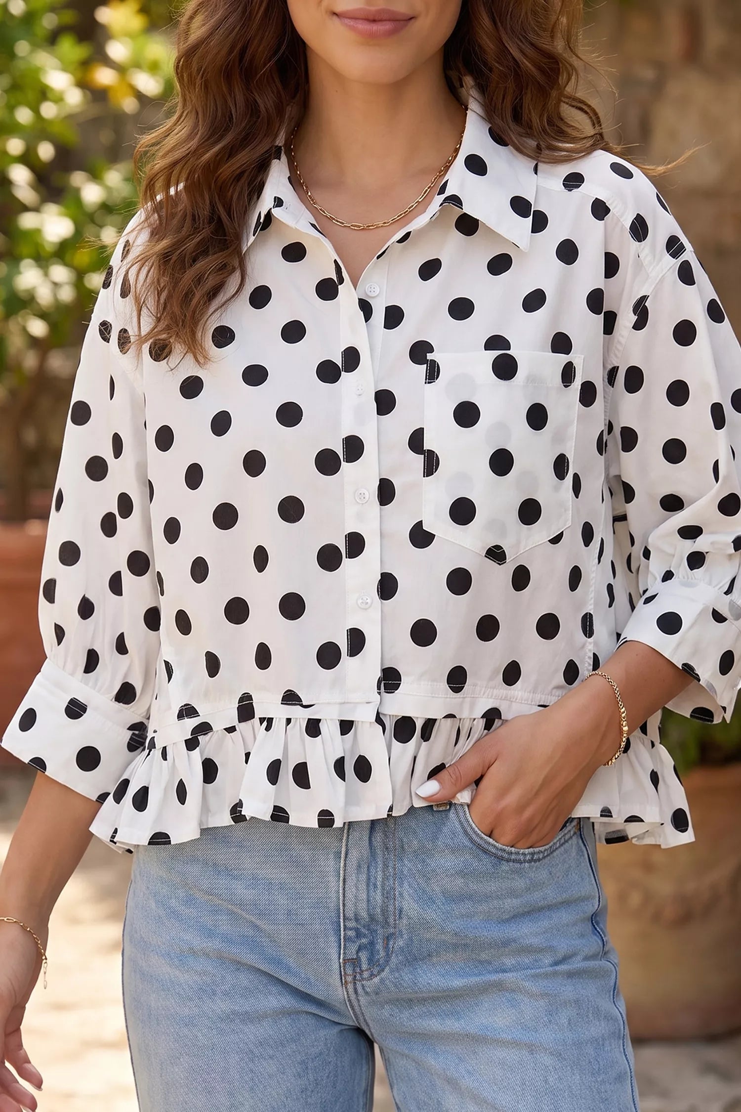 Polka dot print three-quarter sleeve casual shirt with ruffle hem by Trendsi, showcasing soft fabric and stylish design.