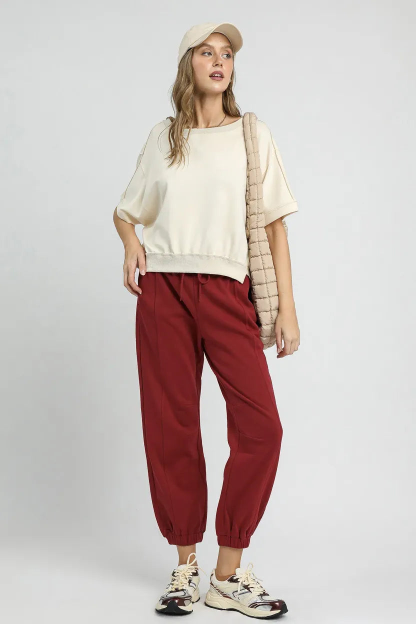 Soft beige Umgee fleece jogger pants with drawstring waist and relaxed fit, ideal for casual and lounge wear.