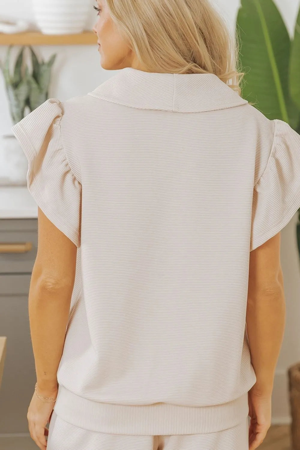 Beige textured ruffled sleeve zipped top with matching wide-leg pants set from Trendsi, stylish and comfortable for casual wear.