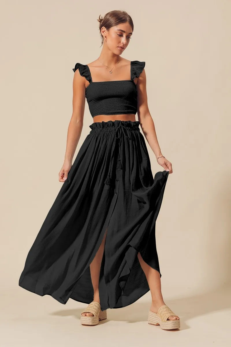 Black SO ME smocked top and flowy maxi skirt set by Trendsi, featuring a stylish, comfortable matching outfit with relaxed fit.