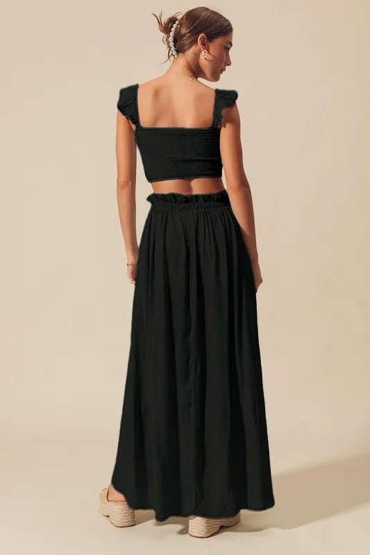 Black SO ME smocked top and flowy maxi skirt set by Trendsi, featuring a stylish, comfortable matching ensemble.