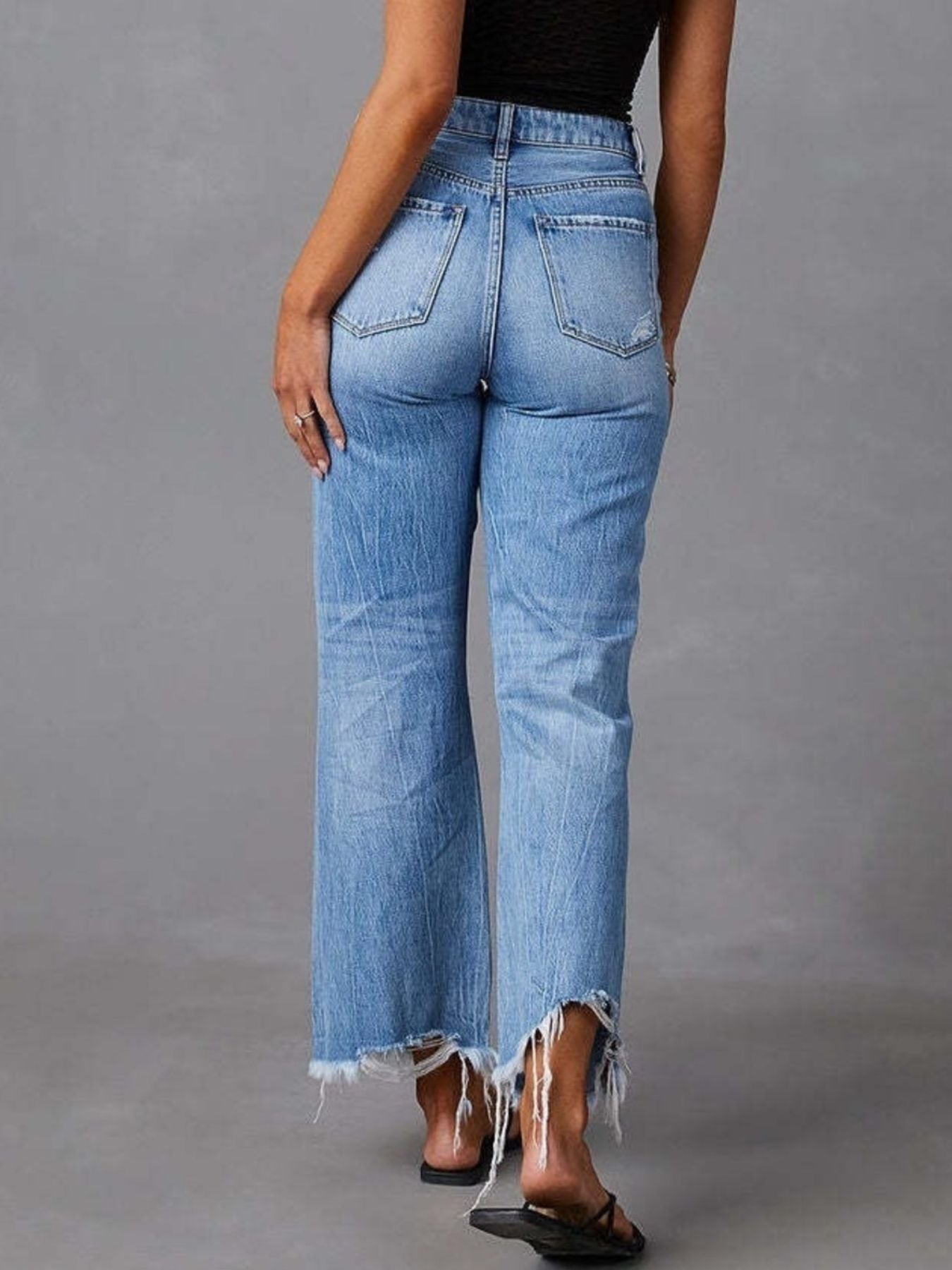 Blue distressed raw hem flare jeans by Trendsi featuring a high-waisted fit and frayed hem detail.
