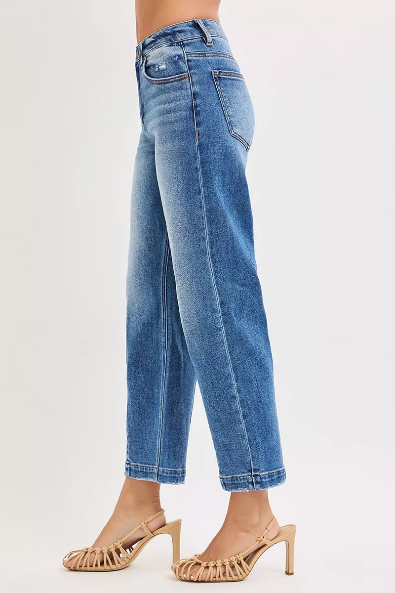 Dark wash Risen high-rise crop boyfriend tapered jeans from Trendsi, showing relaxed fit and tapered leg design.