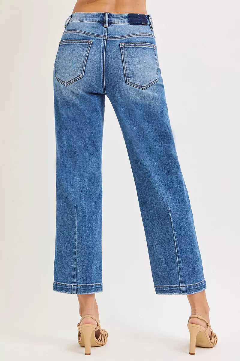 Dark wash Risen High Rise Crop Boyfriend Tapered Jeans by Trendsi, shown on a model, with a relaxed fit and tapered leg style.