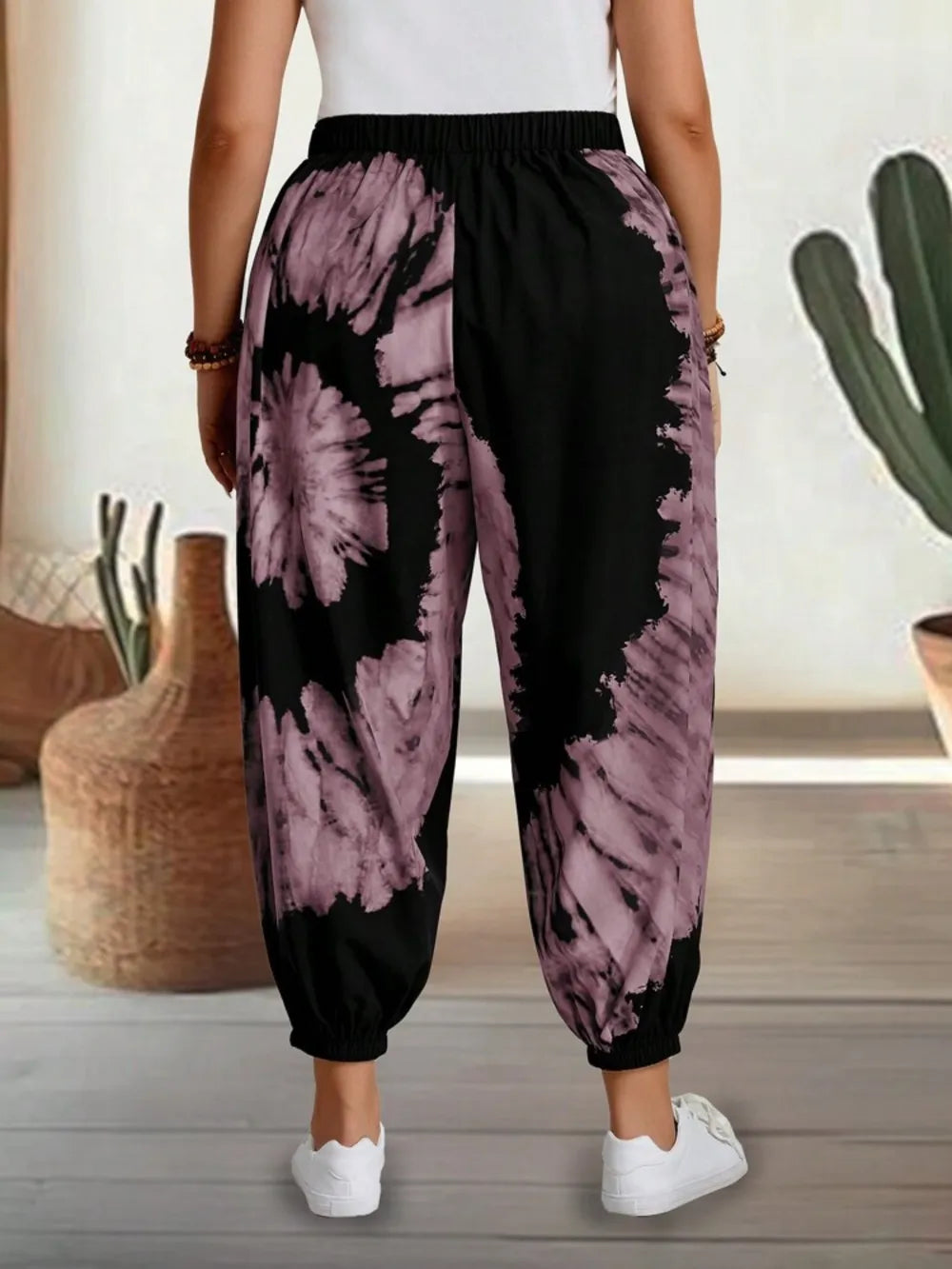 Dusty pink tie-dye elastic waist pants by Trendsi, featuring a relaxed fit and vibrant pattern, perfect for casual wear.