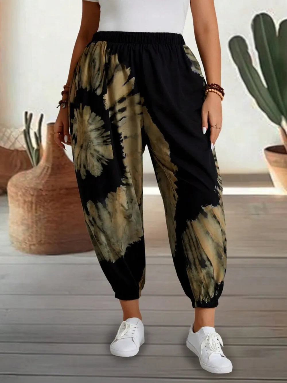 Dusty pink tie-dye elastic waist pants from Trendsi, featuring comfortable fit and vibrant pattern, perfect for casual wear.
