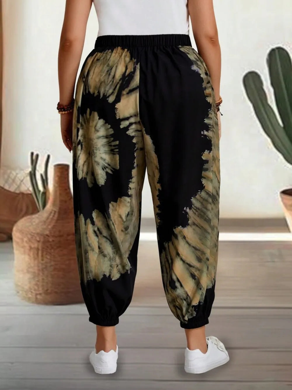 Dusty pink tie-dye elastic waist pants by Trendsi, featuring a relaxed fit and vibrant pattern for casual, comfortable style.