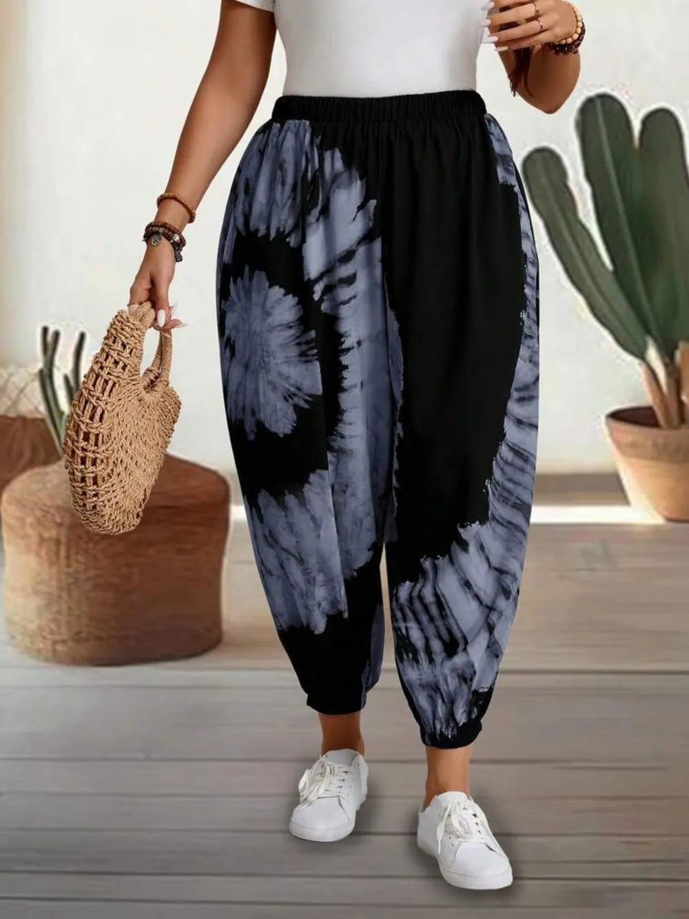 Dusty pink tie-dye elastic waist pants from Trendsi, featuring a relaxed fit and vibrant, colorful pattern.