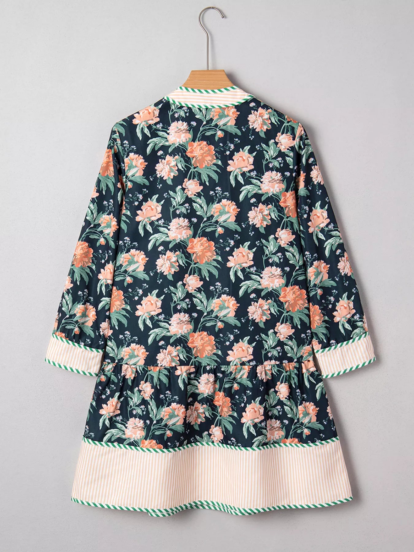 Floral print striped trim V-neck long sleeve shift mini dress with ruffle hem by Trendsi, featuring a vibrant floral pattern and casual style.