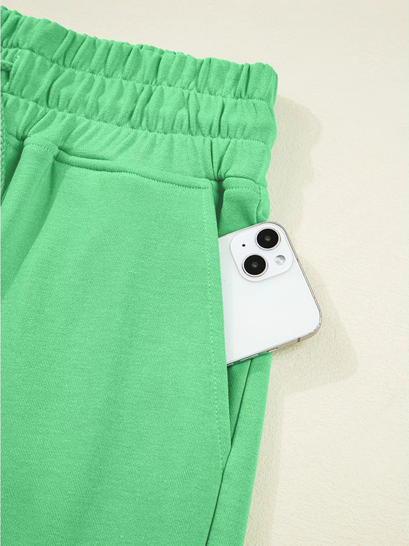 Green drop shoulder puff sleeve crop top with wide-leg drawstring pants set by Trendsi, casual stylish ensemble.