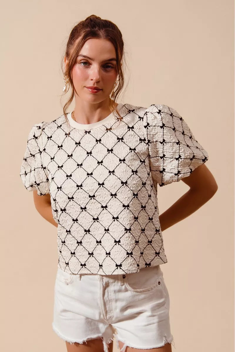 Ivory SO ME Bow Texture Woven Bubble Sleeve Top by Trendsi, featuring a bow detail and textured fabric, styled with long sleeves.