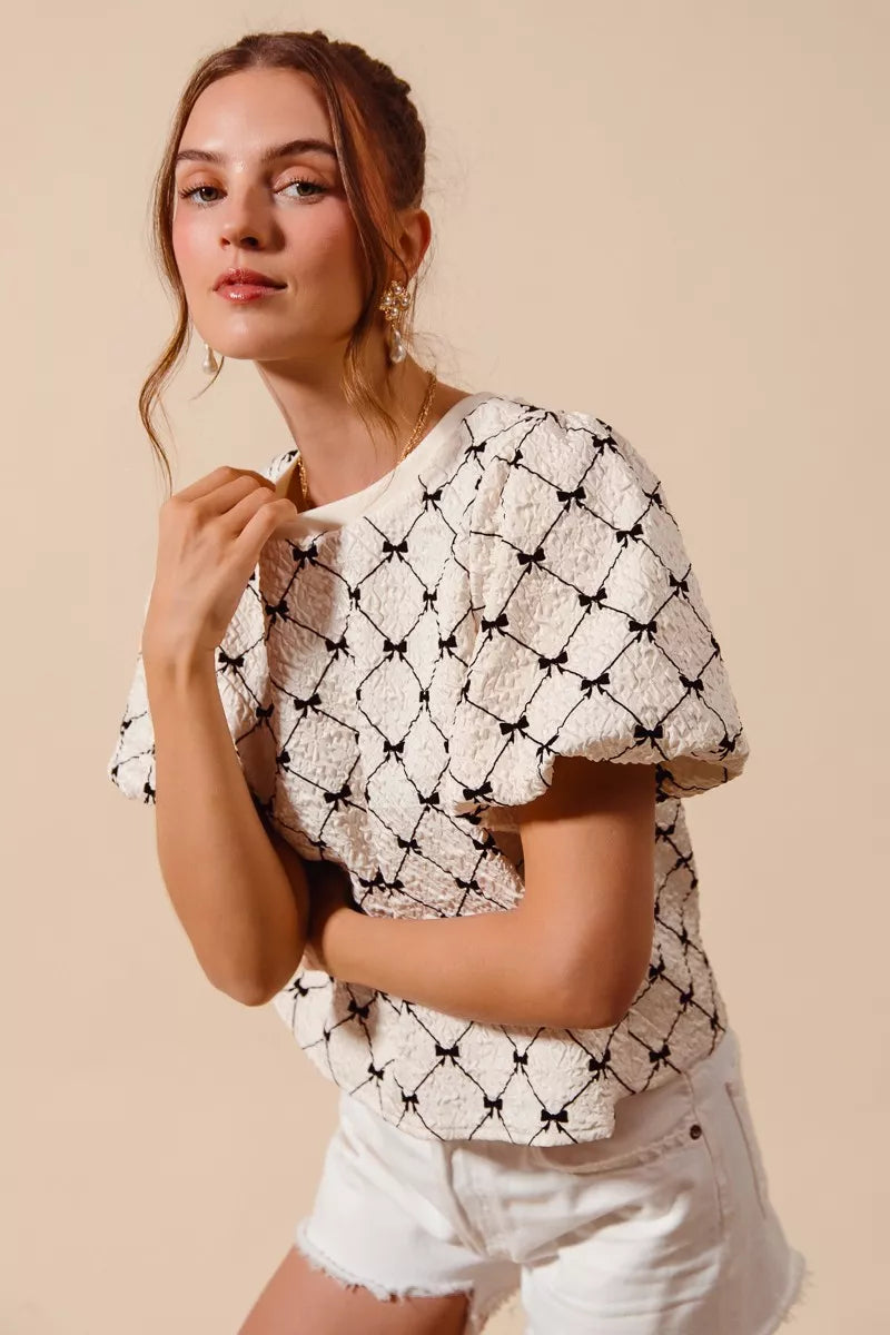 Ivory SO ME Bow Texture Woven Bubble Sleeve Top with stylish puffed sleeves and intricate woven design, by Trendsi.