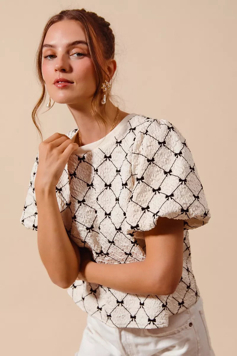 Ivory SO ME bow texture woven bubble sleeve top by Trendsi featuring a stylish bow detail and textured fabric.