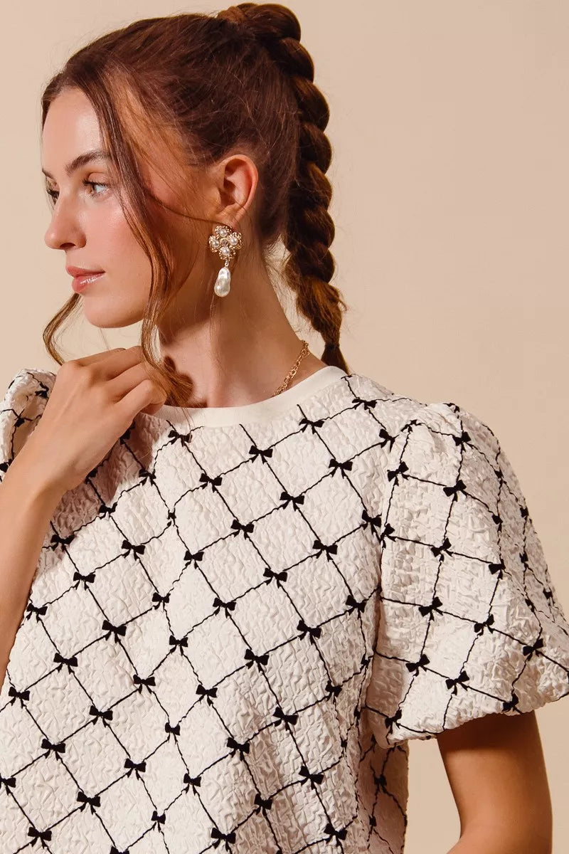 Ivory SO ME Bow Texture Woven Bubble Sleeve Top by Trendsi, featuring a stylish bow detail and textured fabric with puffed sleeves.