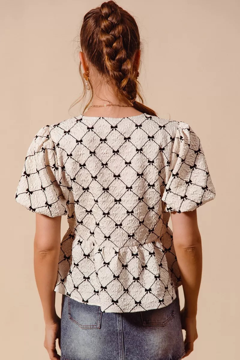 Ivory woven peplum top by Trendsi featuring bow texture, contrast tie, and stylish design, perfect for casual or dressy occasions.
