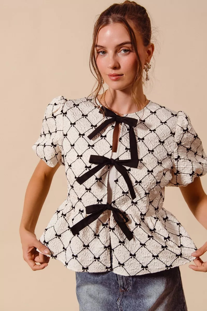 Ivory woven peplum top with bow texture and contrast tie, stylish Trendsi women's fashion blouse.