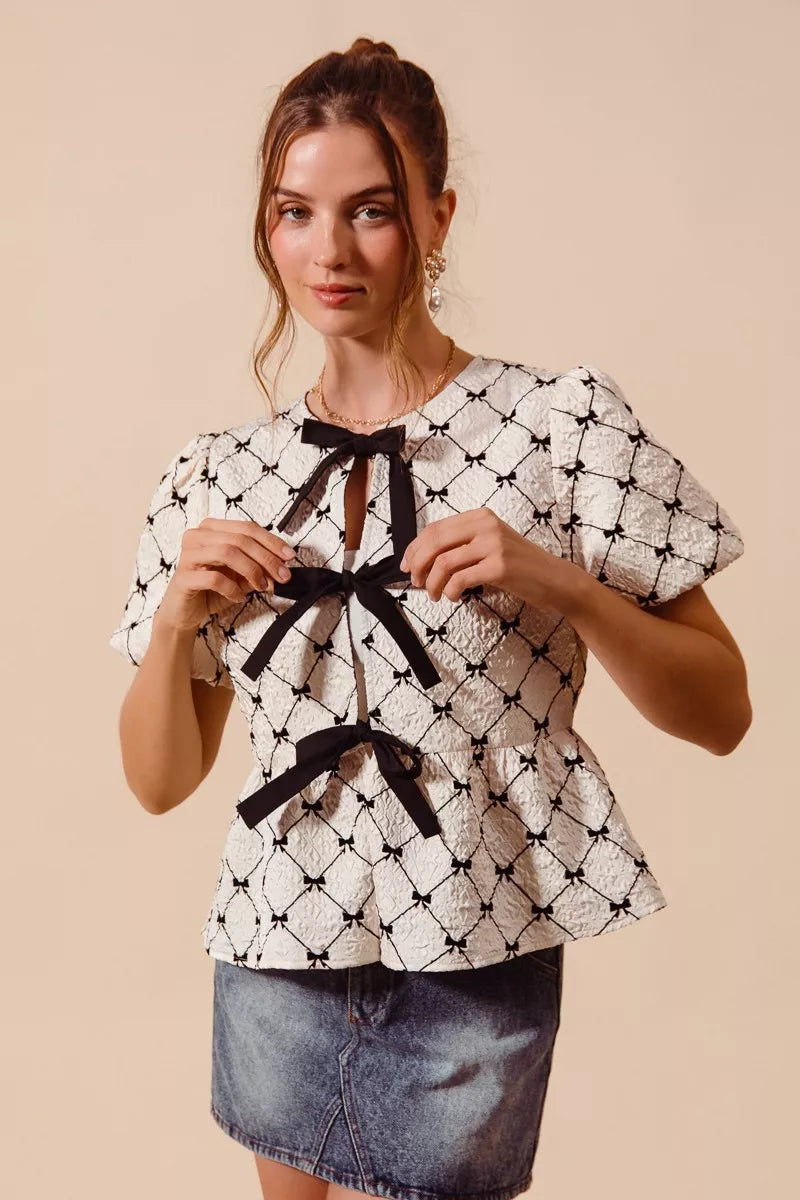 Ivory woven peplum top with bow texture and contrast tie by Trendsi, front view showing stylish design and fabric details.