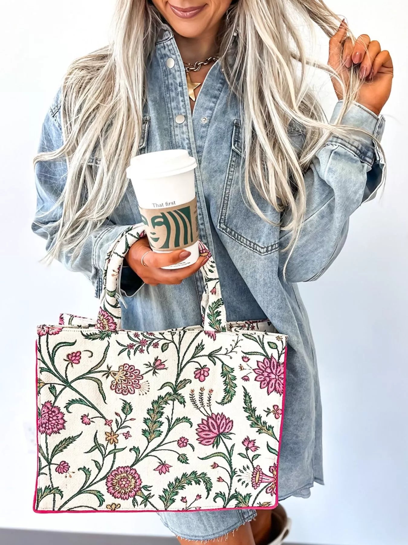 Light blue loose denim shirt dress with chest pockets and raw hem, featuring a relaxed fit and casual style.